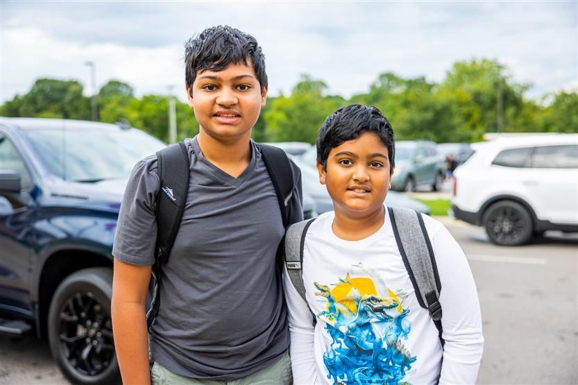 Two students smile
